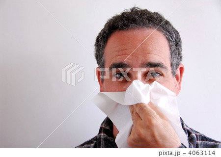 Sick man blowing nose 4063114