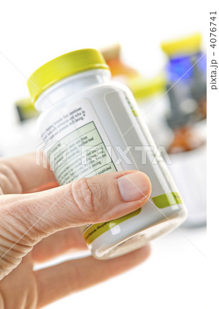 Hand holding medicine bottle 4076741