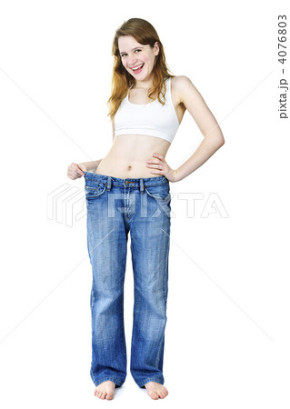Happy girl in jeans after losing weight 4076803
