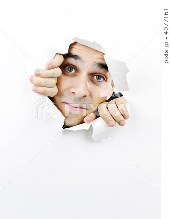 Face looking through hole in paper Face looking through hole in paper 4077161