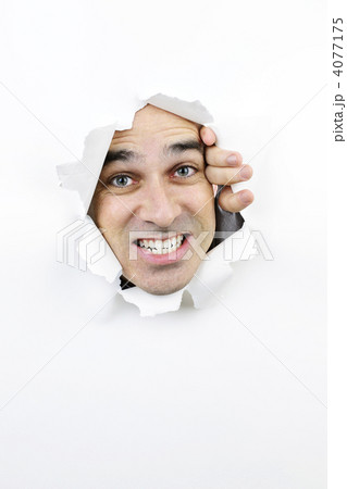 Face looking through hole in paper 4077175