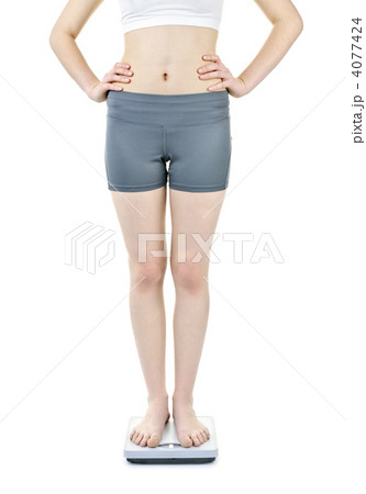 Woman standing on bathroom scale Woman standing on bathroom scale 4077424