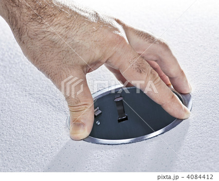 Hands installing metal pot light fixture Hands installing metal pot light fixture 4084412