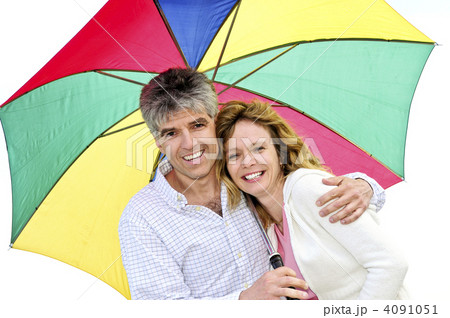 Happy mature couple with umbrella 4091051
