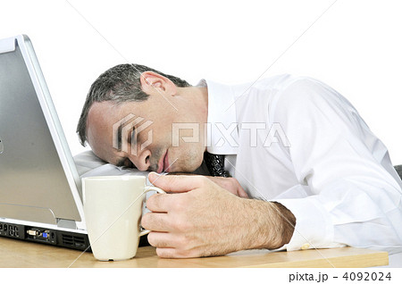 Businessman asleep at his desk on white background 4092024