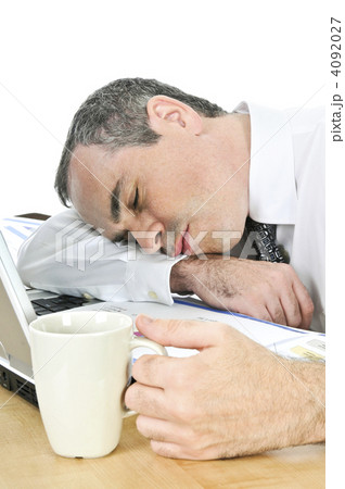 Businessman asleep at his desk on white background 4092027