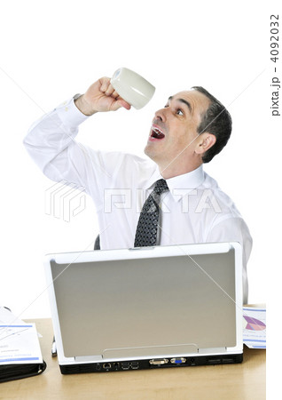 Overworked businessman at his desk on white background 4092032