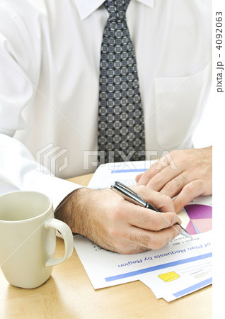 Office worker writing on reports Office worker writing on reports 4092063