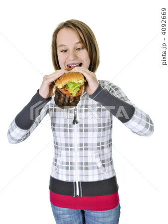 Teenage girl eating big hamburger 4092669