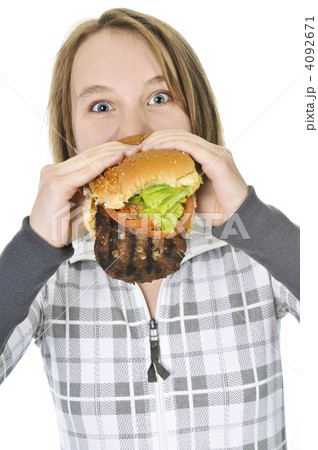 Teenage girl eating big hamburger 4092671