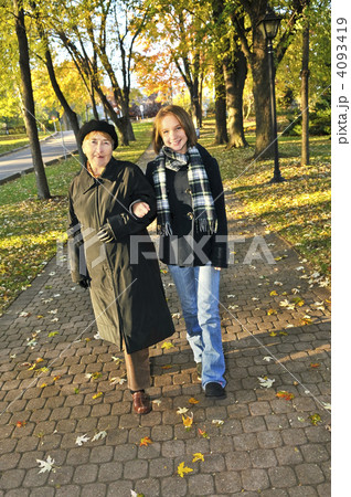 Granddaughter walking with grandmother 4093419