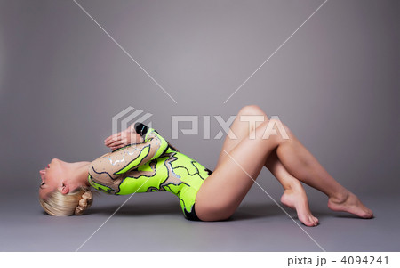 Beauty woman in gymnast suit posing on grey Beauty woman in gymnast suit posing on grey 4094241
