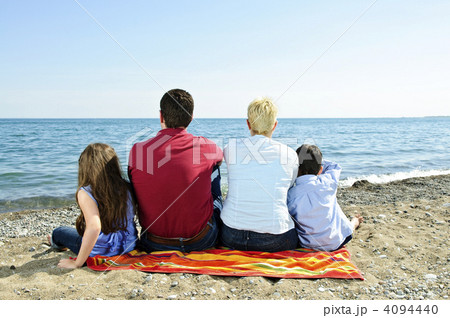 Family sitting at beach 4094440