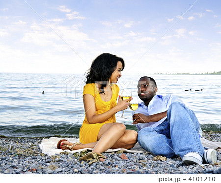 Happy couple having wine on beach 4101210
