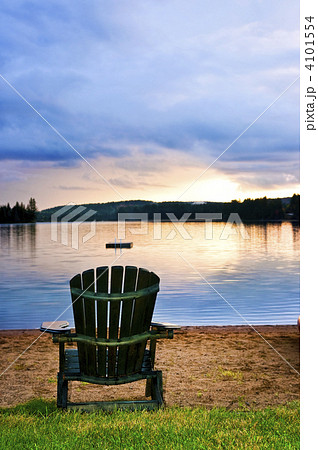 Wooden chair at sunset on beach 4101554