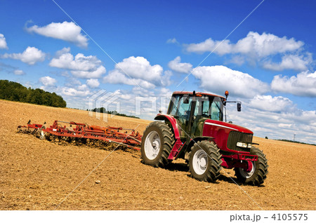 Tractor in plowed field Tractor in plowed field 4105575