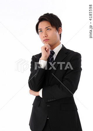 悩んでいるスーツ姿の男性の写真素材