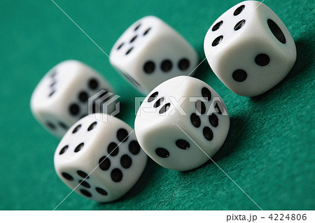 Gambling die on a green surface. 4224806