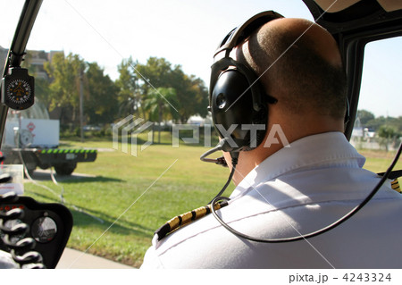 pilot in cockpit of helicopter 4243324
