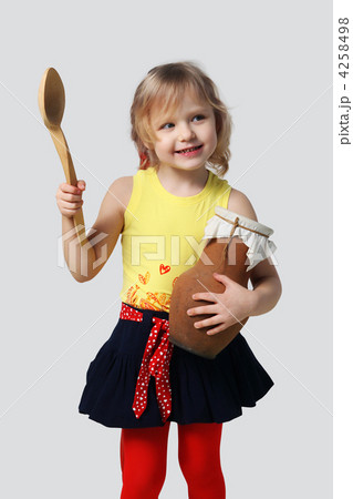 Little girl with a wooden spoon and crock 4258498