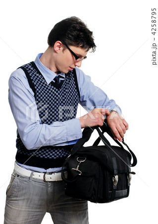 young man with a bag of looking at the watch 4258795