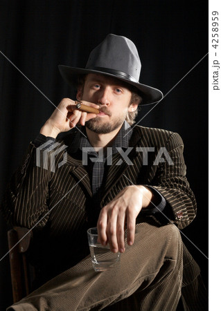 A man with glass of whiskey and cigar 4258959
