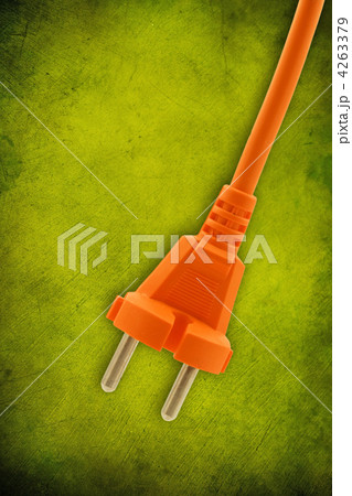 orange electrical plug on  green background 4263379