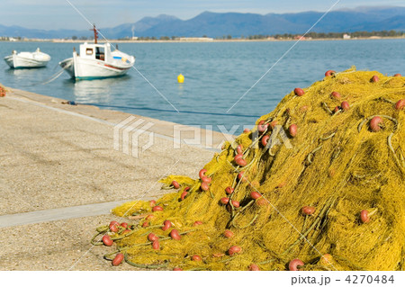 End of fishing day. White boats and yellow fishing net with clea 4270484