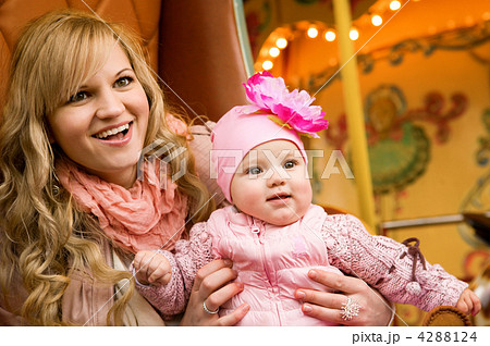 Happy beautiful young mother and her baby daughter taking a ride 4288124