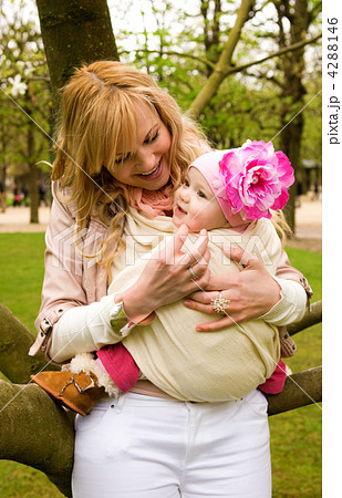 Beautiful young mother and baby daughter having fun outdoors at Beautiful young mother and baby daughter having fun outdoors at 4288146
