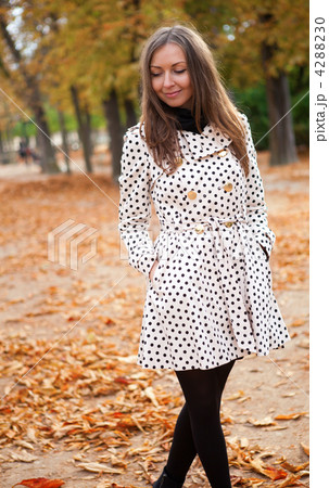 Beautiful young woman in polka dot trench at fall Beautiful young woman in polka dot trench at fall 4288230