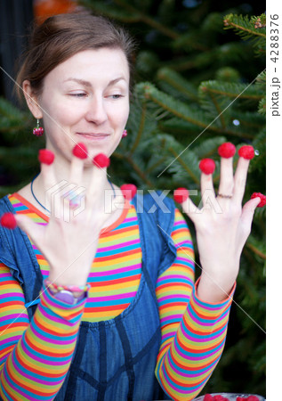 Beautiful young girl in bright clothes poses as Amelie with rasp 4288376
