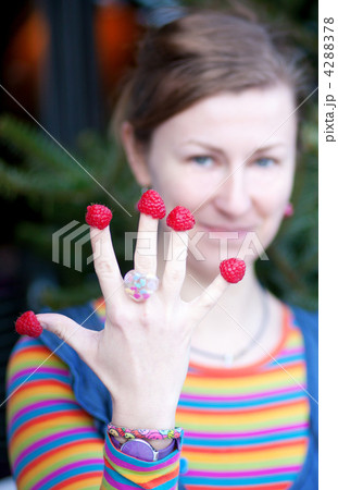 Beautiful young girl in bright clothes poses as Amelie with rasp 4288378