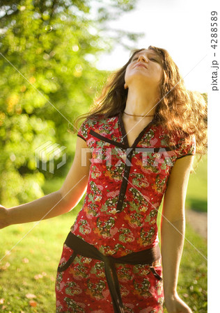 Beautiful young woman enjoying warm sunny day 4288589