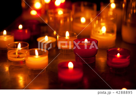 Church candles in red and yellow transparent chandeliers 4288895