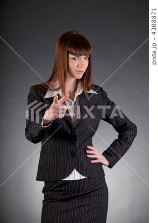Serious looking business woman pointing in camera Serious looking business woman pointing in camera 4308871