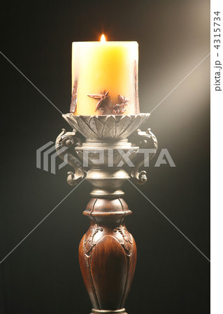 Antique wooden candlestick with ray of light 4315734