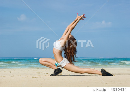 Young woman making exercise on the beach. 4350434