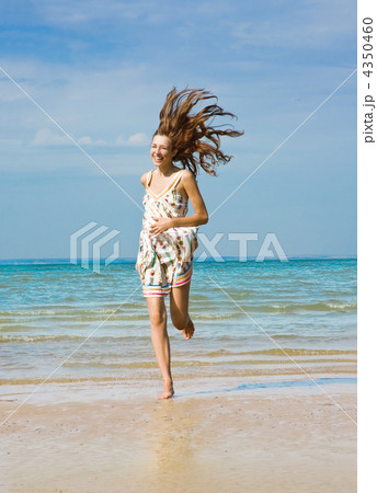 Young woman running alone on the beach Young woman running alone on the beach 4350460