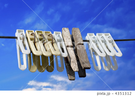 Laundry. Clothes pegs on rope against blue sky background 4351312