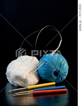 colorful yarn balls with needles and knitting hooks over black colorful yarn balls with needles and knitting hooks over black 4351661