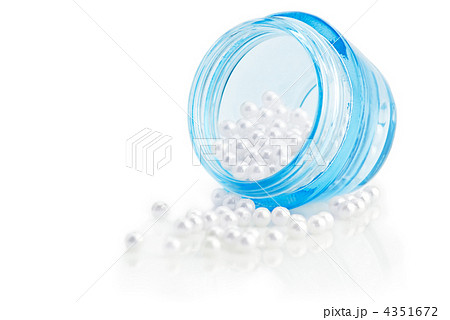 Cosmetic cream container with natural pearls isolated on white b 4351672
