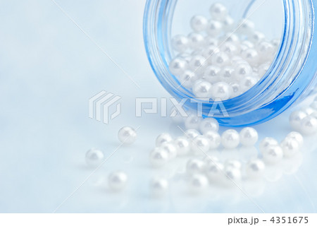Cosmetic cream container with natural pearls over blue sky imita Cosmetic cream container with natural pearls over blue sky imita 4351675