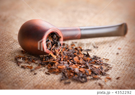 Smoking pipe and tobacco on linen canvas background Smoking pipe and tobacco on linen canvas background 4352292