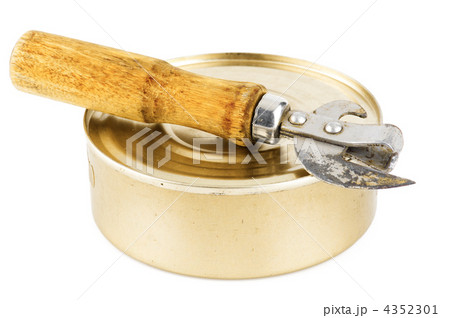 Old dirty tin can opener with wooden handle and closed food tin 4352301