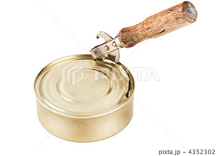 Old dirty tin can opener with wooden handle opening tin can with Old dirty tin can opener with wooden handle opening tin can with 4352302