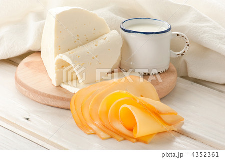 Breakfast with milk and cheese on old wooden table with linen ta 4352361
