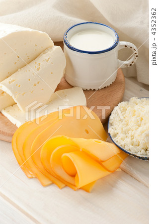 Breakfast with milk and cheese on old wooden table with linen ta 4352362