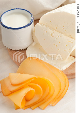 Breakfast with milk and cheese on old wooden table with linen ta Breakfast with milk and cheese on old wooden table with linen ta 4352363