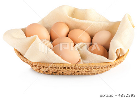 Macro of brown eggs in wooden basket on linen canvas. White back 4352595